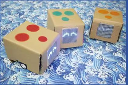 Three CheChe tracking robots with colour-coded markers